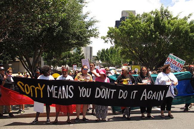 Aboriginal and Torres Strait Islander activists march through the Brisbane business district in the running up to the G20 to protest governmental indigenous policies. Brisbane, Australia 10/11/14