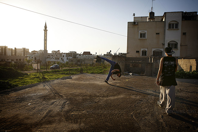 X-Games members perform against the city's skyline. Qalqilya, Palestine