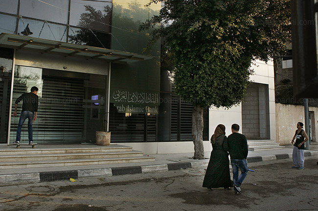 Out of the ordinary. Abdullah on the steps of the Islamic Bank. Qalqilya, Palestine