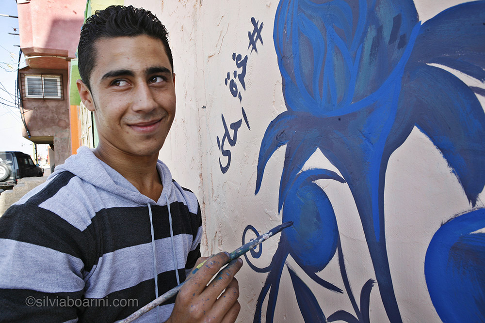Mohammad Akila 20, lives in Shati and helps the Palestinian artists with the make-over of the normally grey buildings. "It's a beautiful idea, the kids will be happy and Shati will look really good." Shati, Gaza